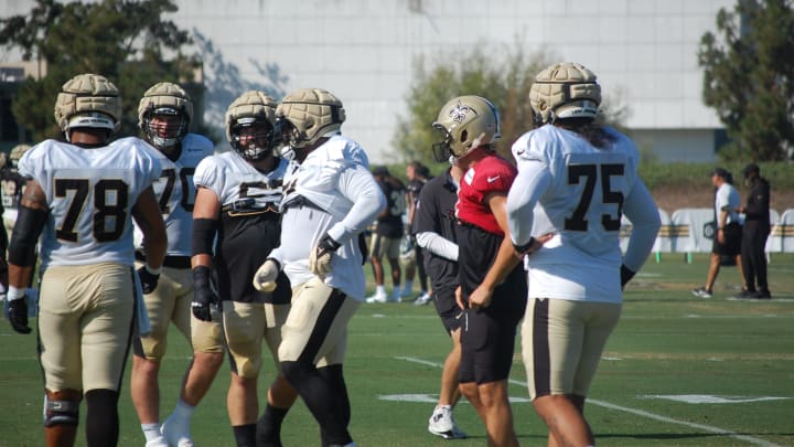 Derek Carr and the Saints offensive line at training camp.