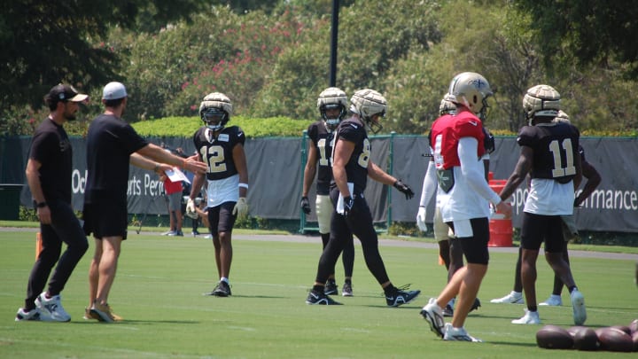 Chris Olave and some of the Saints offense at training camp.