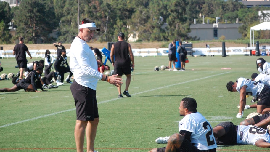 Dennis Allen and Johnathan Abram have a chat during stretch on Day 3 of Saints training camp. | Hendrix Media | Saints News Network