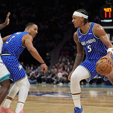 Oct 30, 2025; Charlotte, North Carolina, USA; Orlando Magic forward Paolo Banchero (5) handles the ball against the Charlotte Hornets during the first quarter at Spectrum Center. Mandatory Credit: Jim Dedmon-Imagn Images