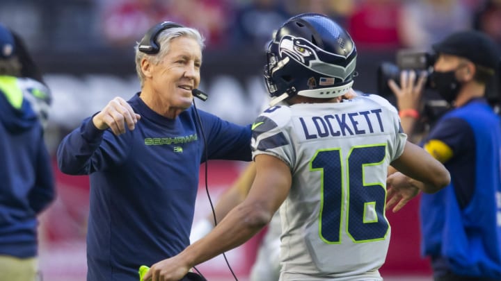 Jan 9, 2022; Glendale, Arizona, USA; Seattle Seahawks head coach Pete Carroll (left) hugs wide receiver Tyler Lockett (16) prior to the game against the Arizona Cardinals at State Farm Stadium.