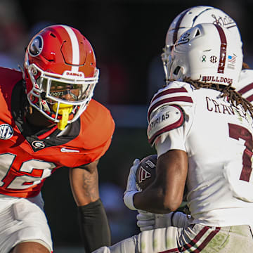 Oct 12, 2024; Athens, Georgia, USA; Georgia Bulldogs defensive back Julian Humphrey (12) tries got tackle Mississippi State Bulldogs wide receiver Mario Craver (7) at Sanford Stadium. Mandatory Credit: Dale Zanine-Imagn Images