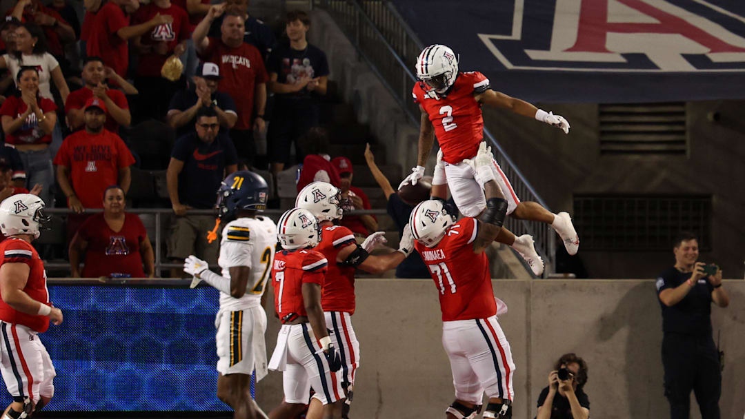 Sep 7, 2024; Tucson, Arizona, USA; Arizona Wildcats wide receiver Jeremiah Patterson (2) celebrates touchdown with Arizona Wildcats offensive lineman Jonah Savaiinaea (71) during third quarter against Northern Arizona Lumberjacks at Arizona Stadium. Mandatory Credit: Aryanna Frank-Imagn Images