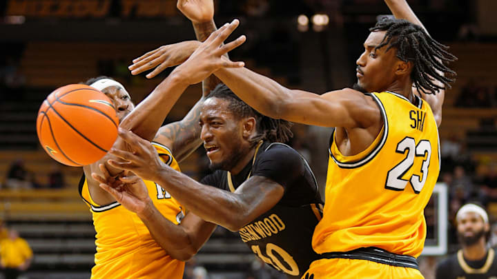 Nov 27, 2024; Columbia, Missouri, USA; Lindenwood Lions guard Jadis Jones (10) passes the ball against Missouri Tigers guard Marcus Allen (4) and guard Aidan Shaw (23) during the first half at Mizzou Arena. Mandatory Credit: Jay Biggerstaff-Imagn Images