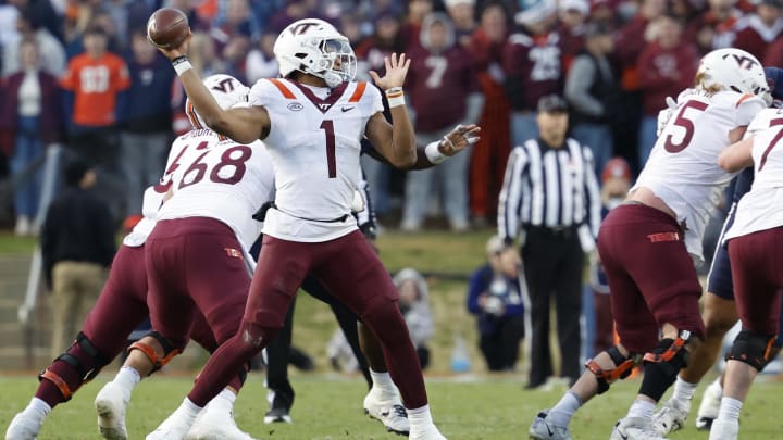 Nov 25, 2023; Charlottesville, Virginia, USA; Virginia Tech Hokies quarterback Kyron Drones (1) passes the ball against the Virginia Cavaliers during the second quarter at Scott Stadium. Mandatory Credit: Geoff Burke-USA TODAY Sports