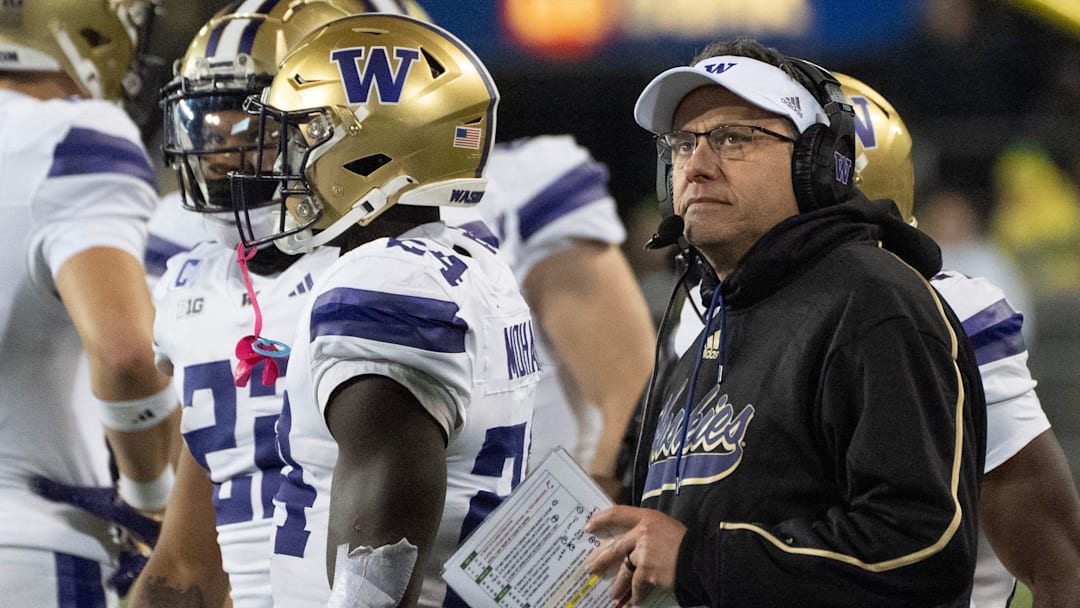 Washington football coach Jedd Fisch looks at the scoreboard during the second quarter at Autzen Stadium in Eugene.