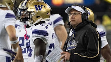 Washington football coach Jedd Fisch looks at the scoreboard during the second quarter at Autzen Stadium in Eugene.