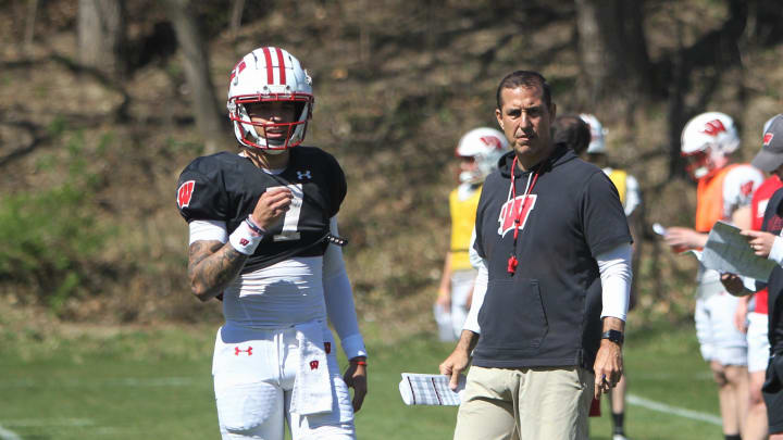 Wisconsin quarterback Nick Evers takes part in practice outside of Camp Randall Stadium in Madison, Wisconsin as coach Luke Fickell watches on Saturday April 13, 2024. Evers announced his intention to transfer from Wisconsin later that day.