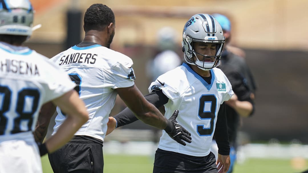 Carolina Panthers QB Bryce Young high-fives tight end Ja'Tavion Sanders during minicamp at Bank of America Stadium. Carolina Panthers QB Bryce Young high-fives tight end Ja'Tavion Sanders during minicamp at Bank of America Stadium.