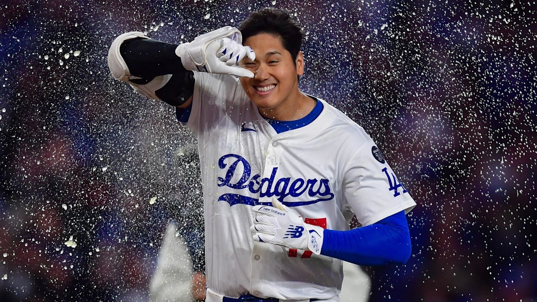 Apr 2, 2025; Los Angeles, California, USA; Los Angeles Dodgers designated hitter Shohei Ohtani (17) is greeted at home after hitting a walk off solo home run against the Atlanta Braves during the ninth inning at Dodger Stadium. Mandatory Credit: Gary A. Vasquez-Imagn Images