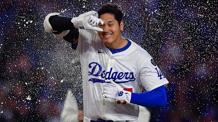 Apr 2, 2025; Los Angeles, California, USA; Los Angeles Dodgers designated hitter Shohei Ohtani (17) is greeted at home after hitting a walk off solo home run against the Atlanta Braves during the ninth inning at Dodger Stadium. Mandatory Credit: Gary A. Vasquez-Imagn Images