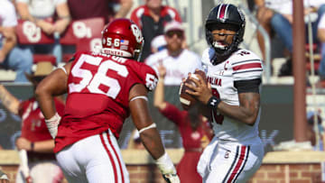 Oct 19, 2024; Norman, Oklahoma, USA; South Carolina Gamecocks quarterback LaNorris Sellers (16) looks to pass as Oklahoma Sooners defensive lineman Gracen Halton (56) defends  during the second half at Gaylord Family-Oklahoma Memorial Stadium. Mandatory Credit: Kevin Jairaj-Imagn Images