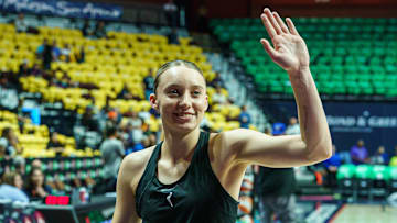 Dallas Wings guard Paige Bueckers waves to fans.