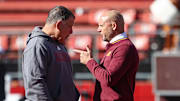 Nov 9, 2024; Piscataway, New Jersey, USA; Rutgers Scarlet Knights head coach Greg Schiano, left, talks with Minnesota Golden Gophers head coach P.J. Fleck before the game at SHI Stadium. Mandatory Credit: Vincent Carchietta-Imagn Images