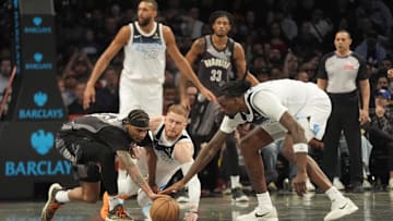 Apr 3, 2025; Brooklyn, New York, USA; Brooklyn Nets guard Keon Johnson (45) and Minnesota Timberwolves shooting guard Donte DiVincenzo (0) and Minnesota Timberwolves center Naz Reid (11) battle for a loose ball during the second half at Barclays Center. Mandatory Credit: Gregory Fisher-Imagn Images