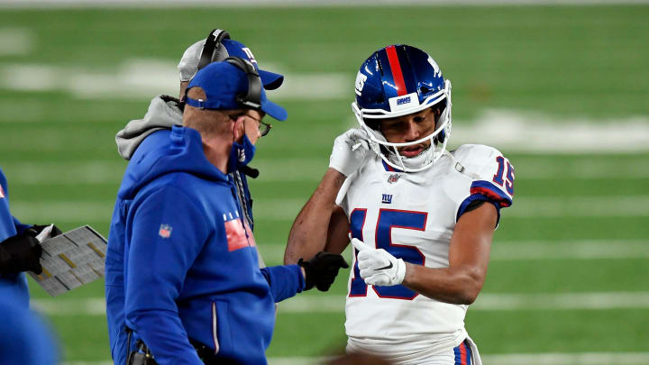 New York Giants offensive coordinator Jason Garrett fist bumps wide receiver Golden Tate (15) after his touchdown catch in the second half. T 