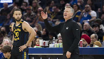 Dec 30, 2024; San Francisco, California, USA;  Golden State Warriors guard Stephen Curry (30) watches as head coach Steve Kerr reacts during the first quarter of the game against the Cleveland Cavaliers against the Cleveland Cavaliers at Chase Center. Mandatory Credit: John Hefti-Imagn Images