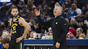 Dec 30, 2024; San Francisco, California, USA;  Golden State Warriors guard Stephen Curry (30) watches as head coach Steve Kerr reacts during the first quarter of the game against the Cleveland Cavaliers against the Cleveland Cavaliers at Chase Center. Mandatory Credit: John Hefti-Imagn Images