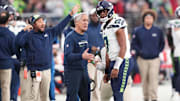 Jan 7, 2024; Glendale, Arizona, USA; Seattle Seahawks head coach Pete Carroll talks with Seattle Seahawks quarterback Geno Smith (7) during the first half of the game against the Arizona Cardinals at State Farm Stadium. 