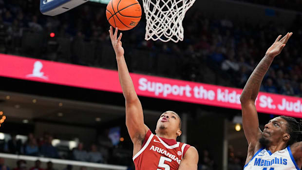 Arkansas' Darius Acuff Jr. (5) goes for a layup as Memphis' Aaron Bradshaw (11) jumps to try and block him