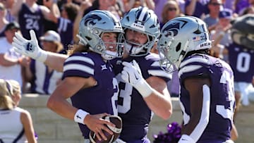 Sep 28, 2024; Manhattan, Kansas, USA; Kansas State Wildcats quarterback Avery Johnson (2) celebrates with running back Dylan Edwards (3) and running back DJ Giddens (31) after scoring a touchdown against the Oklahoma State Cowboys in the first quarter at Bill Snyder Family Football Stadium. Mandatory Credit: Scott Sewell-Imagn Images