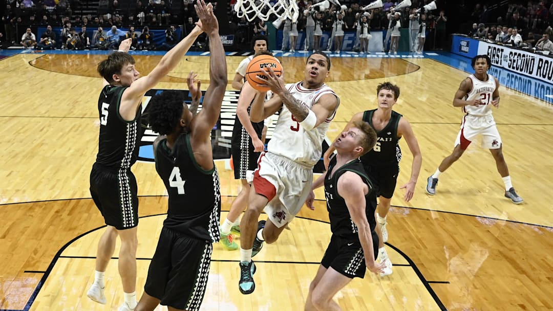 Arkansas Razorbacks guard Darius Acuff Jr. (5) shoots against Hawaii Rainbow Warriors forward Gytis Nemeiksa (5) and guard Dre Bullock (4) in the second half during a first round game of the men's 2026 NCAA Tournament at Moda Center. Mandatory Credit: Troy Wayrynen-Imagn Images Arkansas Razorbacks guard Darius Acuff Jr. (5) shoots against Hawaii Rainbow Warriors forward Gytis Nemeiksa (5) and guard Dre Bullock (4) in the second half during a first round game of the men's 2026 NCAA Tournament at Moda Center. Mandatory Credit: Troy Wayrynen-Imagn Images