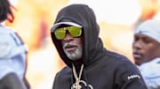 Nov 23, 2024; Kansas City, Missouri, USA;  Colorado head coach Deion Sanders watches his players warmup prior to the game between the Kansas Jayhawks and the Colorado Buffaloes at GEHA Field at Arrowhead Stadium. Mandatory Credit: Nick Tre. Smith-Imagn Images