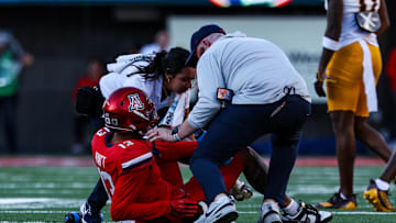 Nov 30, 2024; Tucson, Arizona, USA; Arizona Wildcats wide receiver Devin Hyatt (13) receives medical attention after snapping his ankle during the fourth quarter against the Arizona State Sun Devils at Arizona Stadium. Mandatory Credit: Aryanna Frank-Imagn Images