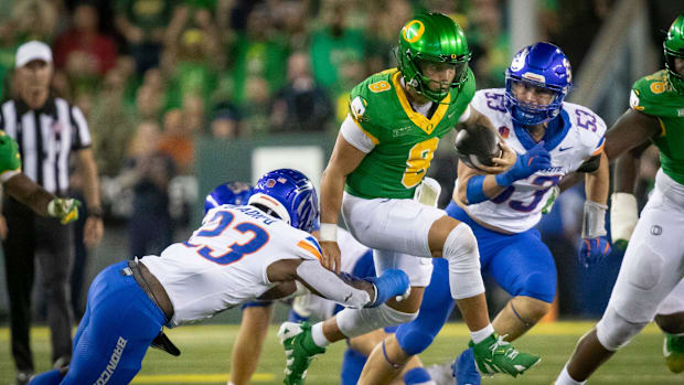 Oregon quarterback Dillon Gabriel scrambles with the ball as the Oregon Ducks host the Boise State Broncos Saturday, Sept. 7,