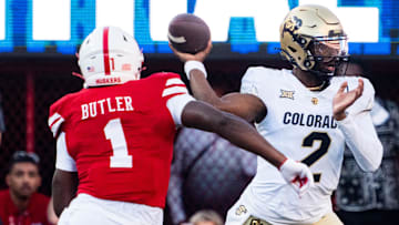 Colorado quarterback Shedeur Sanders passes under pressure from Nebraska defensive end Jimari Butler during the teams' 2024 game in Lincoln. Nebraska head coach Matt Rhule said Monday that Butler and defensive back Marques Buford Jr. plan to return next year for their final season of eligibility.  