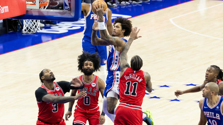 Jan 2, 2024; Philadelphia, Pennsylvania, USA; Philadelphia 76ers guard Kelly Oubre Jr. (9) drives for a shot against Chicago Bulls forward DeMar DeRozan (11) and center Andre Drummond (3) during the third quarter at Wells Fargo Center. Mandatory Credit: Bill Streicher-USA TODAY Sports