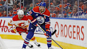 Oct 13, 2024; Edmonton, Alberta, CAN; Edmonton Oilers forward Leon Draisaitl (29) looks to make a pass in front of Calgary Flames forward Name Kadri (91) during the first period at Rogers Place. Mandatory Credit: Perry Nelson-Imagn Images