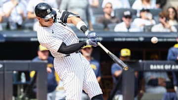 Mar 29, 2025; Bronx, New York, USA; New York Yankees right fielder Aaron Judge (99) hits a solo home run in the first inning against the Milwaukee Brewers at Yankee Stadium. Mandatory Credit: Wendell Cruz-Imagn Images