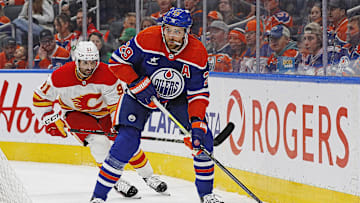 Oct 13, 2024; Edmonton, Alberta, CAN; Edmonton Oilers forward Leon Draisaitl (29) looks to make a pass in front of Calgary Flames forward Name Kadri (91) during the first period at Rogers Place. Mandatory Credit: Perry Nelson-Imagn Images