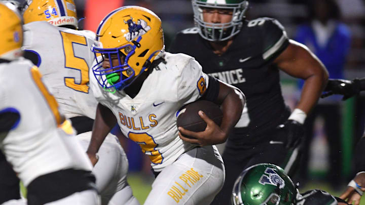 Miami Northwestern ball carrier Elijah Hardy (#8) follows his blockers through a hole in the Venice defensive line. The Venice High Indians hosted the Miami Northwestern Bulls in a non-conference game Friday evening, Aug. 30, 2024.