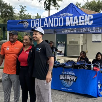 Magic guard Cole Anthony poses with Orlando city leaders at his 50 Ways Foundation Back-to-School Surprise Wednesday night. Mason Williams/Orlando Magic on SI