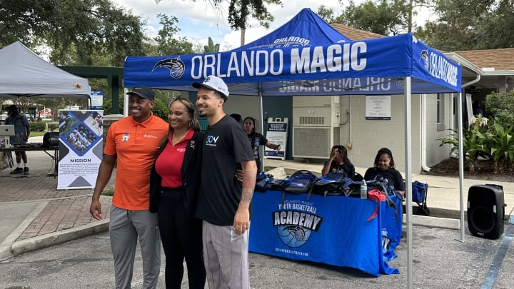 Magic guard Cole Anthony poses with Orlando city leaders at his 50 Ways Foundation Back-to-School Surprise Wednesday night. Mason Williams/Orlando Magic on SI