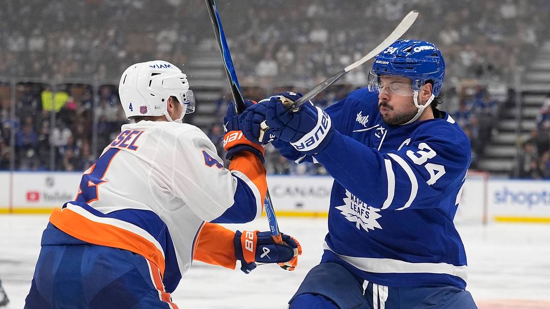 Oct 17, 2026; Toronto, Ontario, CAN;  New York Islanders defenseman Matthew Kessel (4) and Toronto Maple Leafs center Auston Matthews (34) battle for position during the third period at Scotiabank Arena.  Mandatory Credit: John E. Sokolowski-Imagn Images