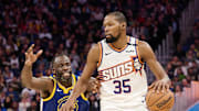 Dec 28, 2024; San Francisco, California, USA; Phoenix Suns forward Kevin Durant (35) controls the ball against Golden State Warriors forward Draymond Green (23) during the third quarter at Chase Center. Mandatory Credit: Robert Edwards-Imagn Images