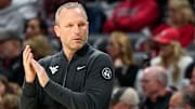 West Virginia Mountaineers head coach Darian DeVries applauds his defense in the first half of the NCAA basketball game between the Cincinnati Bearcats and the West Virginia Mountaineers at Fifth Third Arena in Cincinnati on Sunday, Feb. 2, 2025.