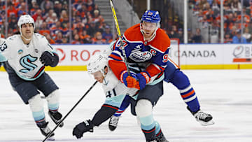 Jan 27, 2025; Edmonton, Alberta, CAN; Seattle Kraken defensemen Ryker Evans (41) checks Edmonton Oilers forward Connor McDavid (97) during the third period at Rogers Place. Mandatory Credit: Perry Nelson-Imagn Images