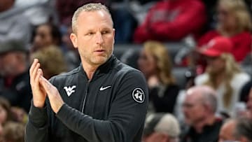 West Virginia Mountaineers head coach Darian DeVries applauds his defense in the first half of the NCAA basketball game between the Cincinnati Bearcats and the West Virginia Mountaineers at Fifth Third Arena in Cincinnati on Sunday, Feb. 2, 2025.