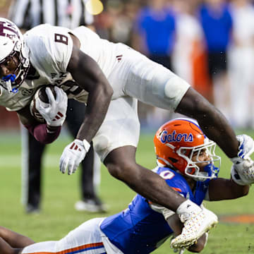 Sep 14, 2024; Gainesville, Florida, USA; Florida Gators defensive back Sharif Denson (0) tackles Texas A&M Aggies running back Le'Veon Moss (8) during the second half at Ben Hill Griffin Stadium. Mandatory Credit: Matt Pendleton-Imagn Images