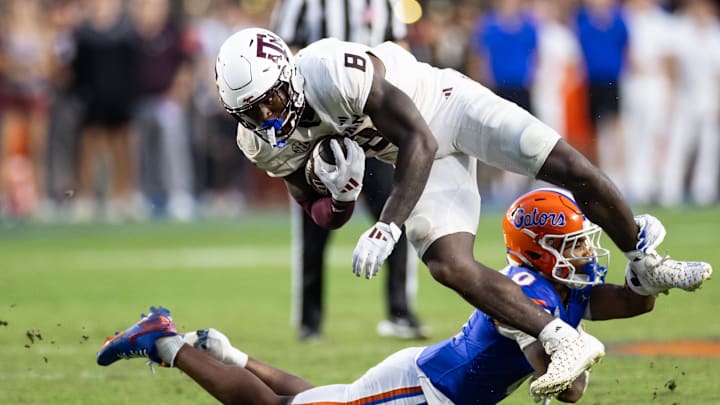 Sep 14, 2024; Gainesville, Florida, USA; Florida Gators defensive back Sharif Denson (0) tackles Texas A&M Aggies running back Le'Veon Moss (8) during the second half at Ben Hill Griffin Stadium. Mandatory Credit: Matt Pendleton-Imagn Images