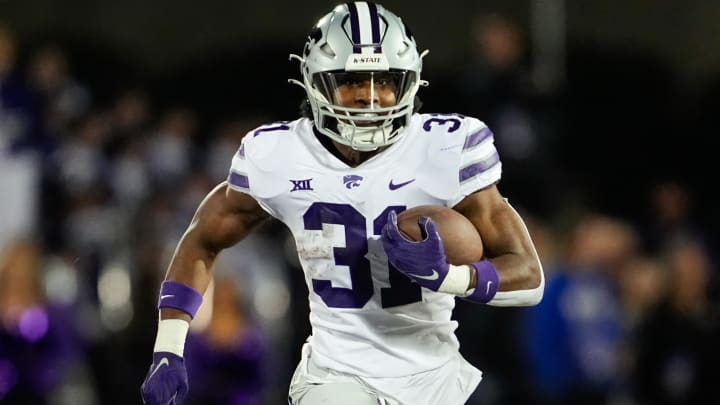 Nov 18, 2023; Lawrence, Kansas, USA; Kansas State Wildcats running back DJ Giddens (31) runs the ball during the first half against the Kansas Jayhawks at David Booth Kansas Memorial Stadium. Mandatory Credit: Jay Biggerstaff-USA TODAY Sports