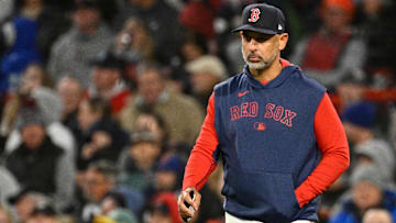 Boston Red Sox manager Alex Cora (13) walks to the mound during the sixth inning against the New York Mets at Fenway Park.
