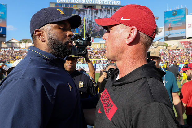 Dec 31, 2024; Tampa, FL, USA;  Michigan Wolverines head coach Sherrone Moore greets Alabama Crimson Tide head coach Kalen Deb