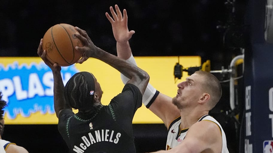 Timberwolves forward Jaden McDaniels shoots against Denver Nuggets center Nikola Jokić.