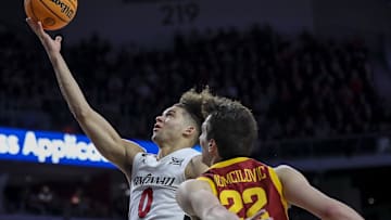 Feb 13, 2024; Cincinnati, Ohio, USA; Cincinnati Bearcats guard Dan Skillings Jr. (0) shoots against Iowa State Cyclones forward Milan Momcilovic (22) in the second half at Fifth Third Arena. Mandatory Credit: Katie Stratman-Imagn Images