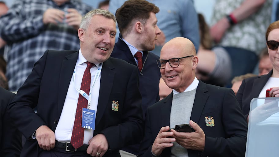 Jason Wilcox (left) and Sir Dave Brailsford laughing together.